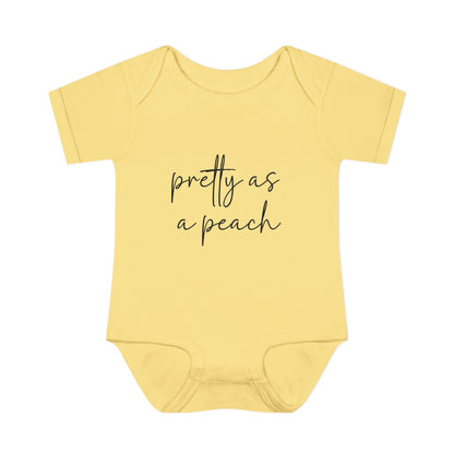 Banana Pretty as a Peach baby bodysuit, front product mockup showing the script design.