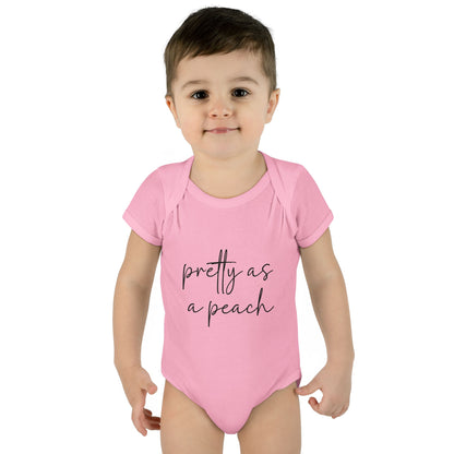 Pink Pretty as a Peach baby bodysuit, worn on a toddler model.