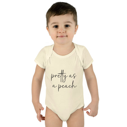 Natural Pretty as a Peach baby bodysuit, worn on a toddler model.