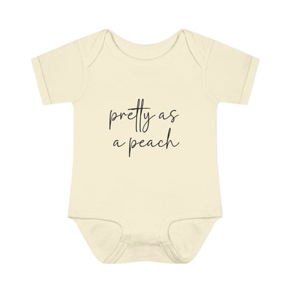 Natural Pretty as a Peach baby bodysuit, front product mockup showing the script design.