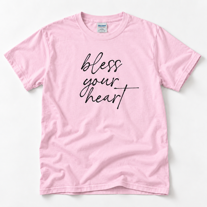 Light Pink Bless Your Heart adult T-shirt laid flat with black script lettering.