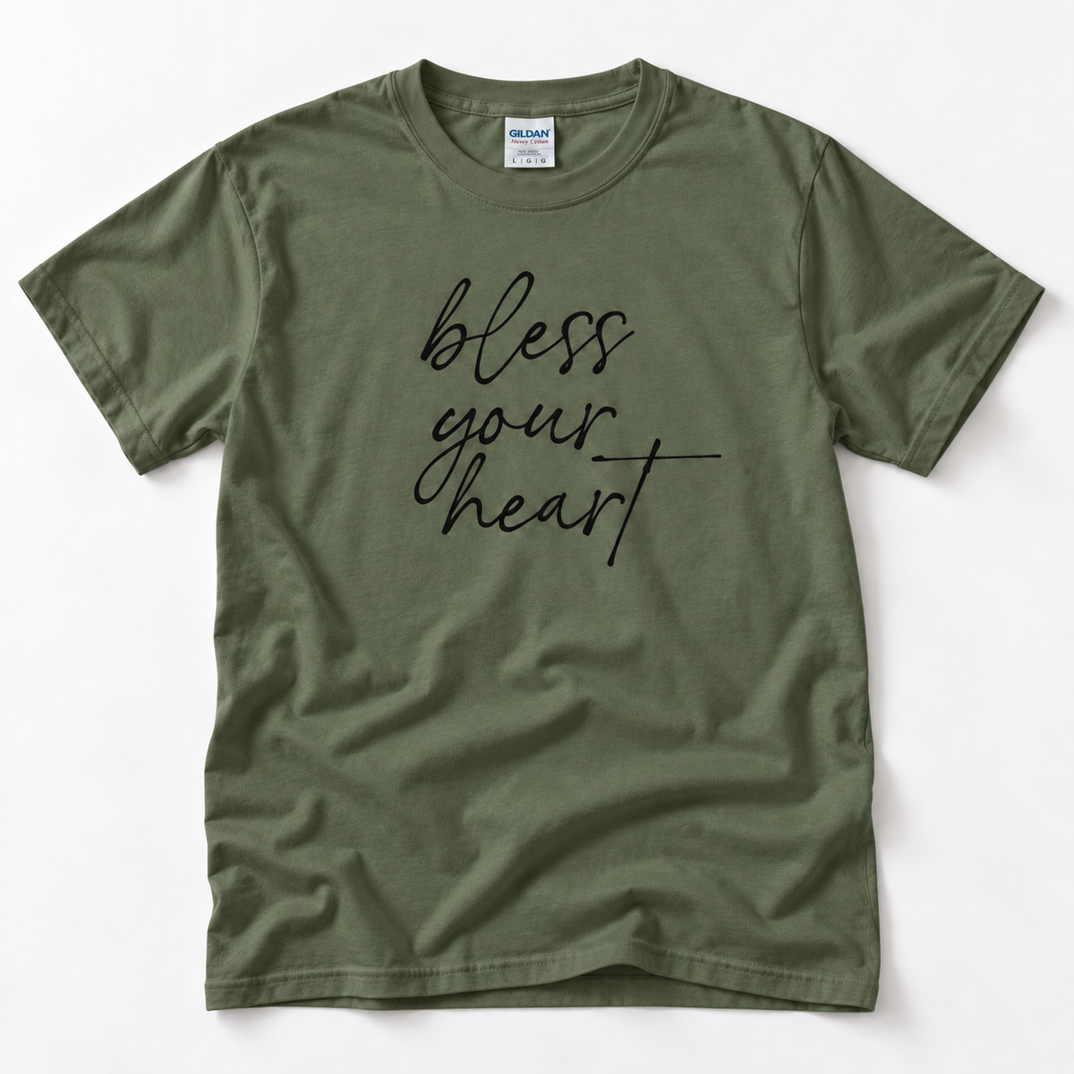Military Green Bless Your Heart adult T-shirt laid flat with black script lettering.