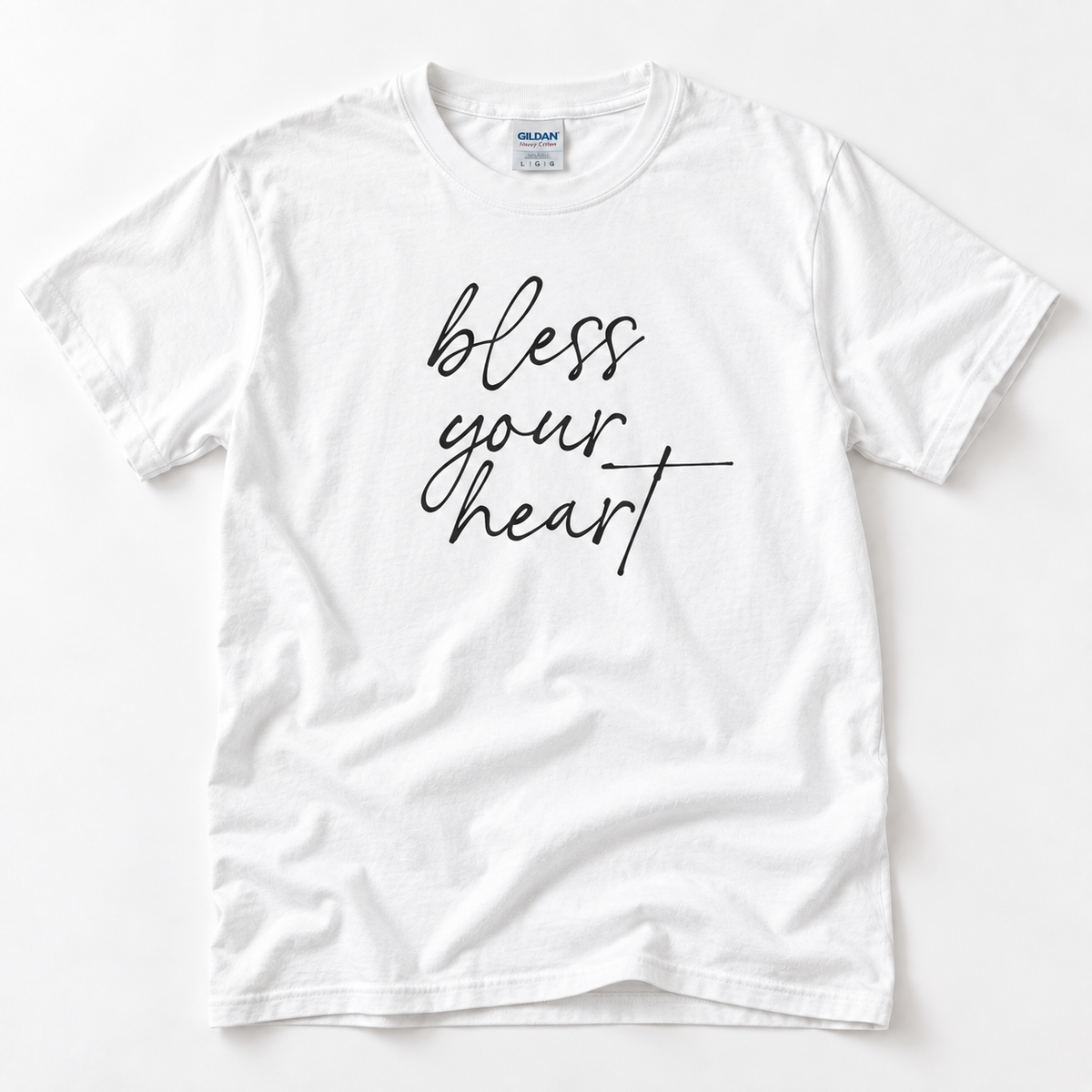 White Bless Your Heart adult T-shirt laid flat with black script lettering.