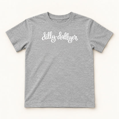 Heather Dilly-Dallyer kids tee with white script, flat on a cream background