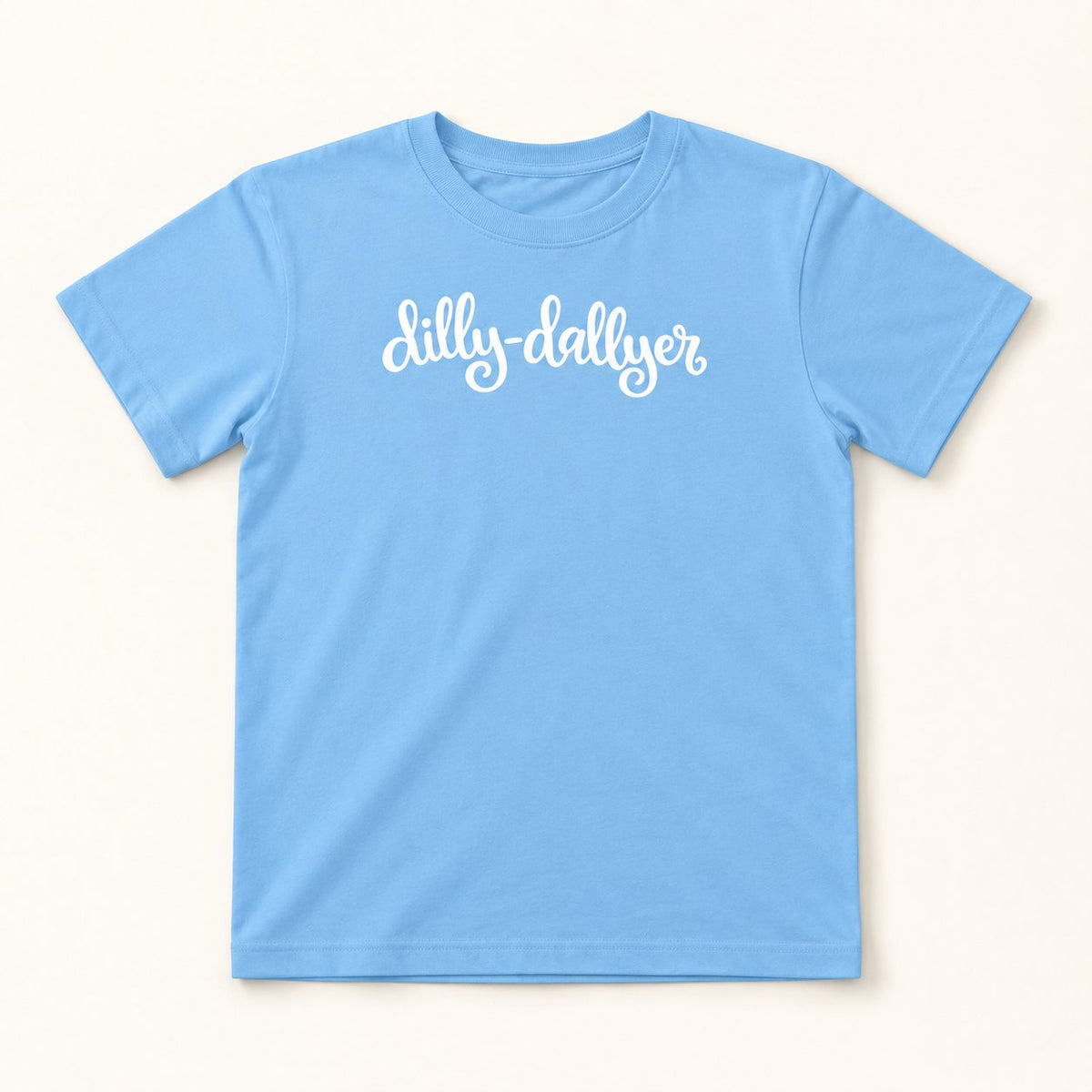 Light Blue Dilly-Dallyer kids tee with white script, flat on a cream background