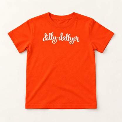 Orange Dilly-Dallyer kids tee with white script, flat on a cream background