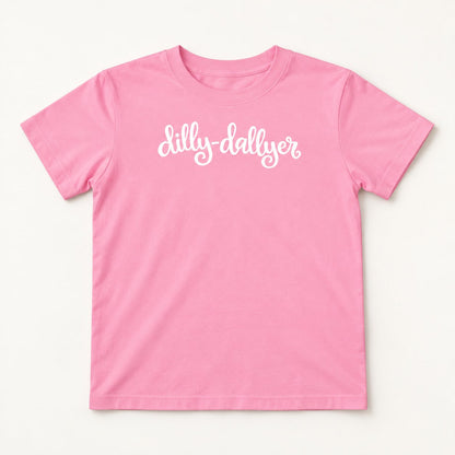 Pink Dilly-Dallyer kids tee with white script, flat on a cream background