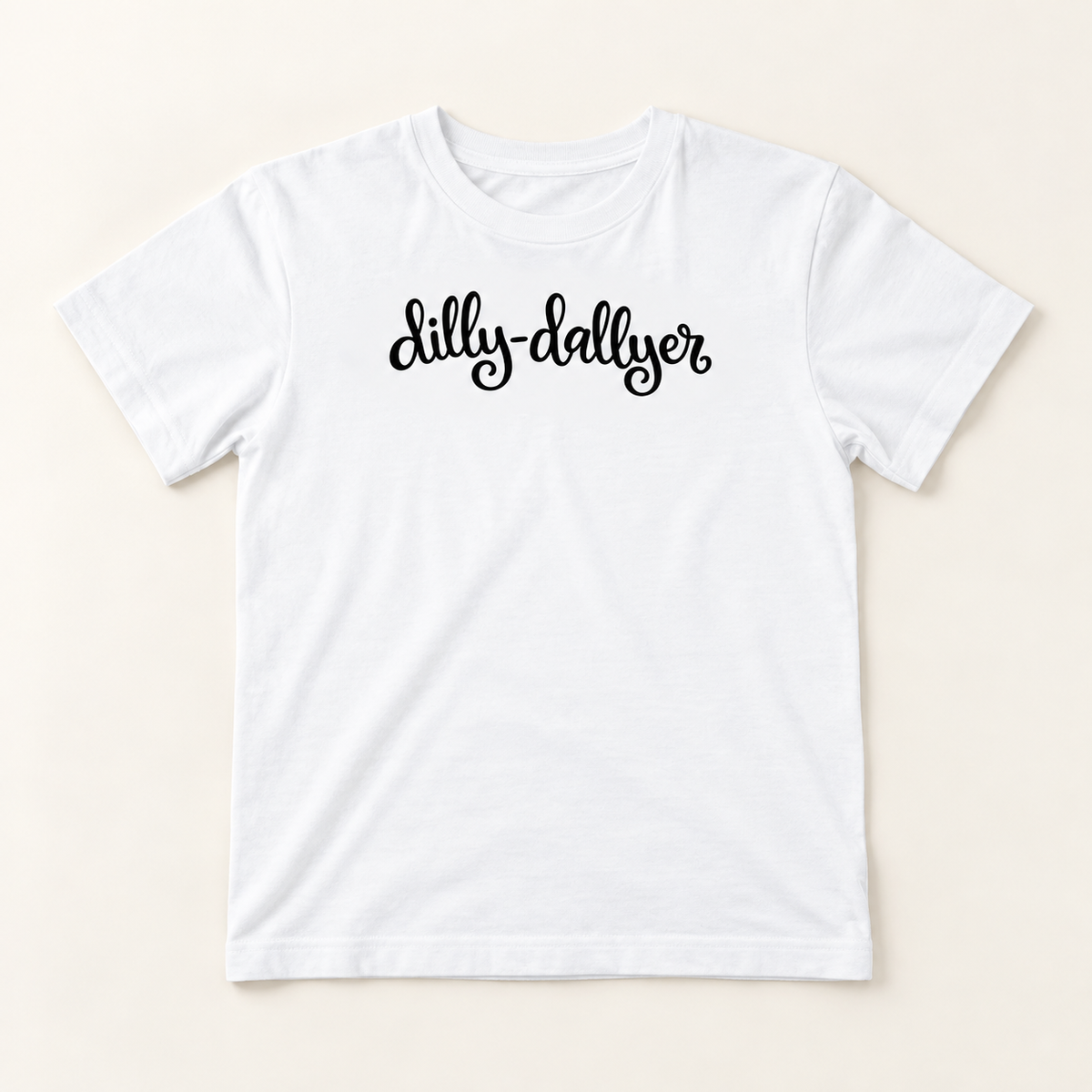 White Dilly-Dallyer big kids tee with black script on a neutral background