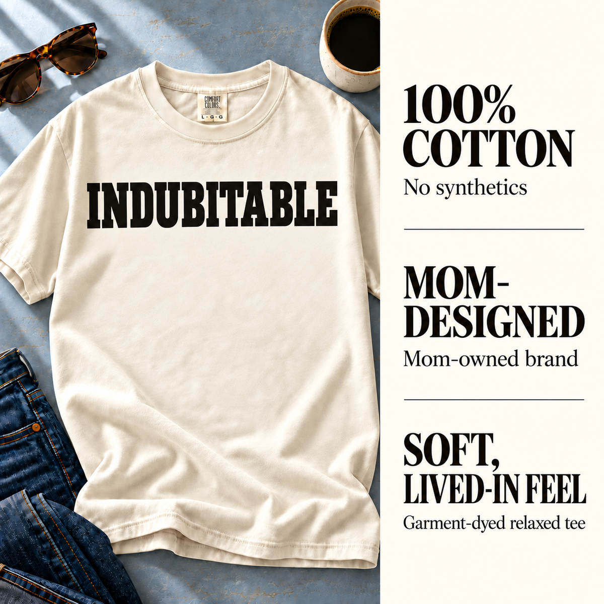 Ivory Indubitable tee beside 100% cotton, mom-owned brand, and garment-dyed fabric details.