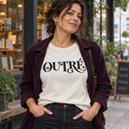 Woman wearing an ivory Outré graphic tee and plum jacket outside a bookstore.
